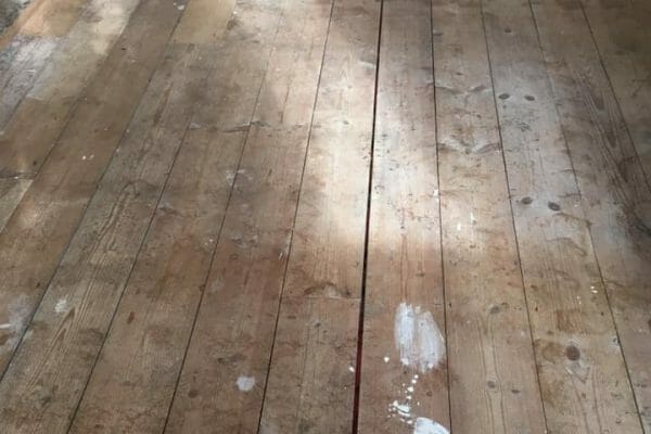 pine floorboards before restoration