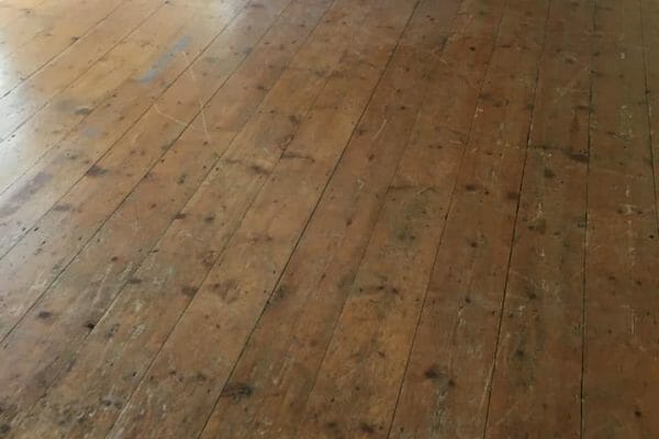 pine floorboards before restoration